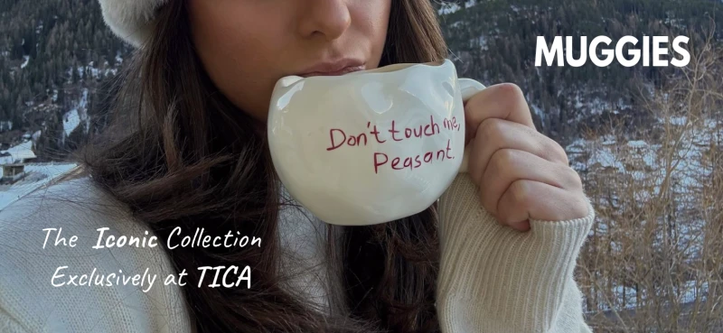 woman holding a mug for sale at TICA while drinking